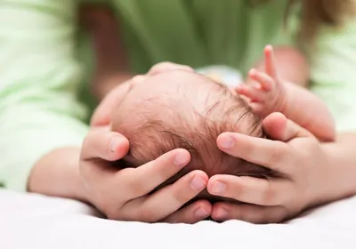 Cute sleeping newborn baby child on mother hands stock photo